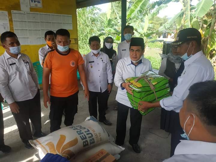 Wali Kota Sungai Penuh, H.Asafri Jaya Bakri (AJB) saat menyalurkan bantuan pangan bagi korban banjir.(ist)