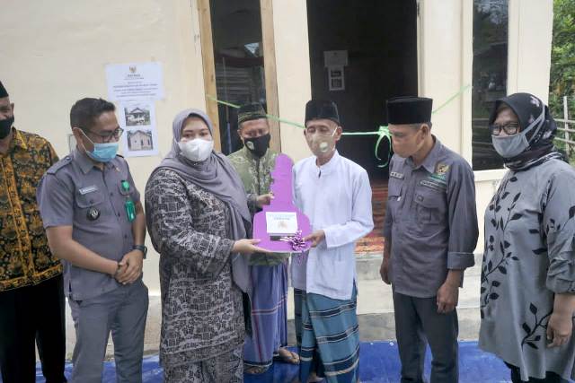 Bupati Masnah serahkan kunci rumah kepada penerima bantuan bedah rumah.
