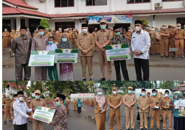 Kegiatan penyerahan piala lomba desa dan penyaluran dana zakat oleh Bupati Kerinci Adirozal.